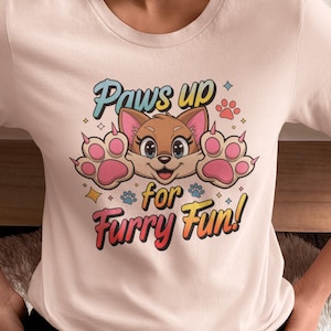 May include: A pink t-shirt with a cartoon dog wearing a pink bow and the text "Paws up for Furry Fun!" printed on the front.