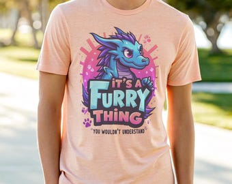 May include: A pink t-shirt with a blue cartoon dragon and the text "It's a Furry Thing You Wouldn't Understand".