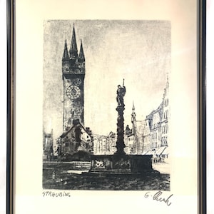 May include: A black and white etching of a city square in Straubing, Germany. The etching features a tall clock tower, a statue in the center of the square, and surrounding buildings. The artist's signature, "G. Berk", is in the lower right corner.