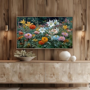 May include: A framed floral painting featuring a vibrant array of colorful flowers. The artwork showcases lilies, zinnias, and other blooms in shades of yellow, orange, pink, and white. The painting is set against a dark green background.