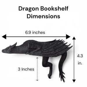 May include: A black dragon bookshelf with dimensions displayed. The dragon is 6.9 inches long, 4.3 inches high, and its legs are 3 inches long. The text "Dragon Bookshelf Dimensions" is at the top.