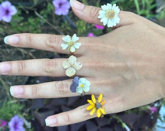 Real dried hand picked resin rings. Adjustable band and hypoallergenic material.