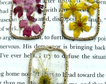 Pressed Butter Cup, Verbena and Wild Aster flower pendants.
