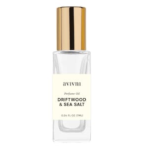 May include: A clear glass perfume oil bottle with a gold cap. The label reads "avivni" and "DRIFTWOOD & SEA SALT". The bottle contains 7ml of perfume oil.