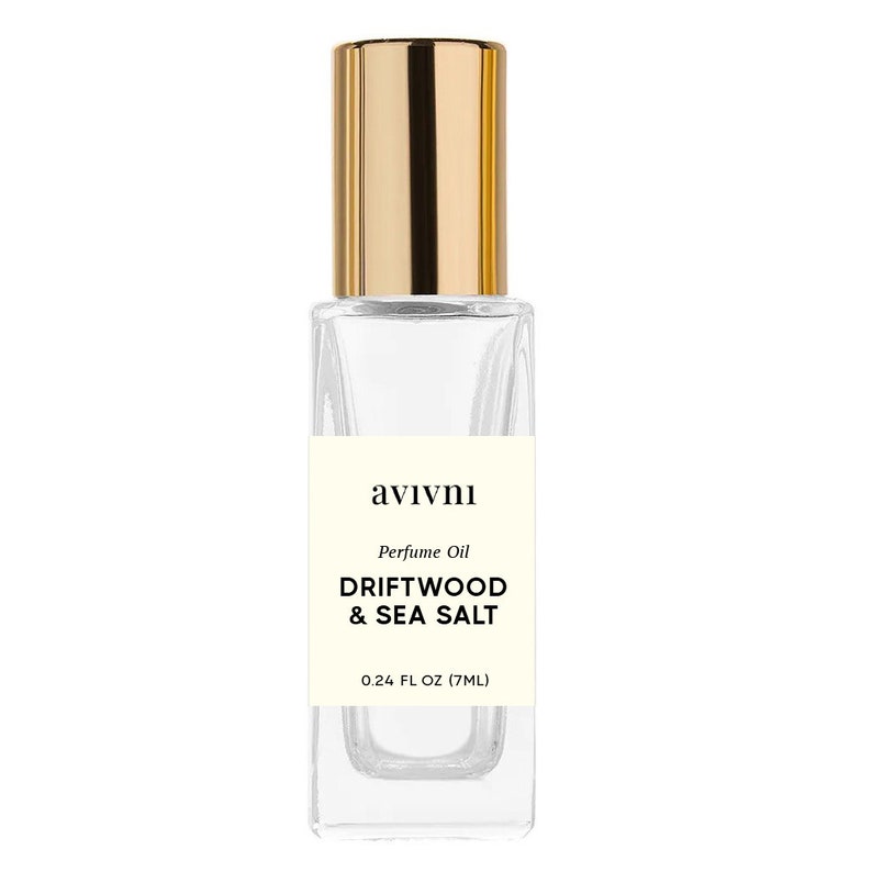 May include: A clear glass perfume oil bottle with a gold cap. The label reads "avivni" and "DRIFTWOOD & SEA SALT". The bottle contains 7ml of perfume oil.