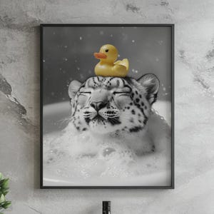 May include: A black and white photo of a snow leopard with its eyes closed, relaxing in a bubble bath. A yellow rubber ducky sits on top of the leopard's head.