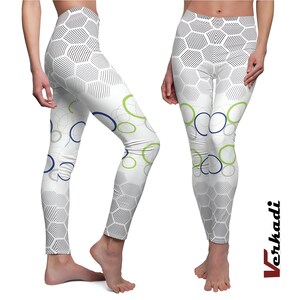 May include: White leggings with a geometric pattern of gray hexagons and striped lines. The design includes blue, green, and gray overlapping circles. The leggings are form-fitting and have a high waist.
