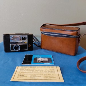 May include: A set of three ceramic mugs with a speckled, matte finish. The mugs are in shades of cream, light gray, and dark gray. Each mug has a simple, minimalist design, perfect for coffee or tea.