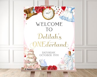 May include: Welcome to Delilah's ONEderland party sign with a pink and white background. The sign features a heart with the text "Welcome to Delilah's ONEderland" in gold lettering. The sign also features a clock, a playing card, a teacup, a bottle, and a cake.