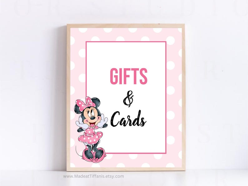 May include: Pink and white polka dot sign with a cartoon image of Minnie Mouse. The sign says "Gifts & Cards".