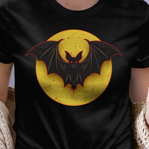 Bat and moon design on a soft t-shirt, perfect gift for Halloween or to celebrate the Fall season