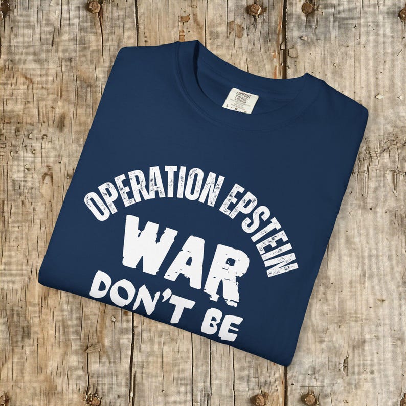 Anti War with Iran Operation Epstein Don't be Distracted. This garment speaks with conviction. A heavyweight, garment-dyed tee printed with a bold, protest-forward message that draws attention without shouting. The soft, broken-in hand of garment dyeing and the relaxed fit make it comfortable for long days at rallies, vigils, or standing on the street holding a sign. Worn by someone who wants their stance to be seen and felt, it layers easily under a jacket or stands alone as a statement piece.