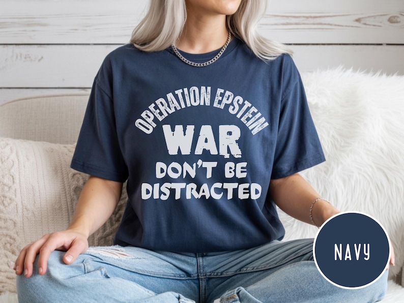 Anti War with Iran Operation Epstein Don't be Distracted. This garment speaks with conviction. A heavyweight, garment-dyed tee printed with a bold, protest-forward message that draws attention without shouting. The soft, broken-in hand of garment dyeing and the relaxed fit make it comfortable for long days at rallies, vigils, or standing on the street holding a sign. Worn by someone who wants their stance to be seen and felt, it layers easily under a jacket or stands alone as a statement piece.