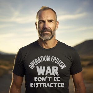 Anti War with Iran Operation Epstein Don't be Distracted. This garment speaks with conviction. A heavyweight, garment-dyed tee printed with a bold, protest-forward message that draws attention without shouting. The soft, broken-in hand of garment dyeing and the relaxed fit make it comfortable for long days at rallies, vigils, or standing on the street holding a sign. Worn by someone who wants their stance to be seen and felt, it layers easily under a jacket or stands alone as a statement piece.