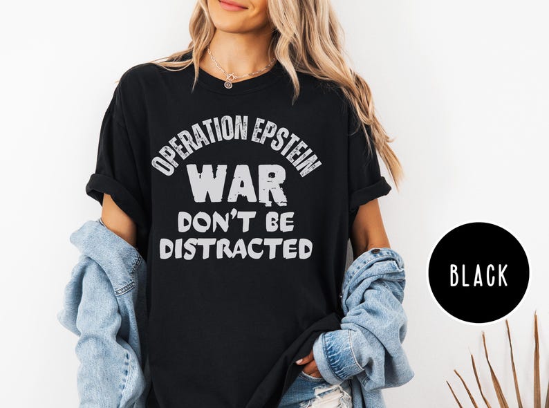 Anti War with Iran Operation Epstein Don't be Distracted. This garment speaks with conviction. A heavyweight, garment-dyed tee printed with a bold, protest-forward message that draws attention without shouting. The soft, broken-in hand of garment dyeing and the relaxed fit make it comfortable for long days at rallies, vigils, or standing on the street holding a sign. Worn by someone who wants their stance to be seen and felt, it layers easily under a jacket or stands alone as a statement piece.