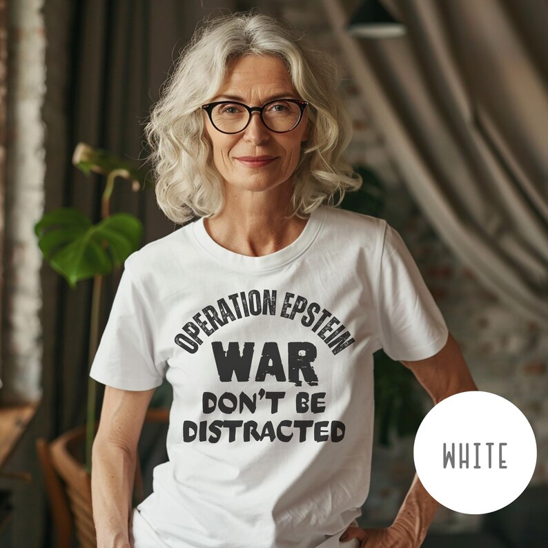 Anti War with Iran Operation Epstein Don't be Distracted. This garment speaks with conviction. A heavyweight, garment-dyed tee printed with a bold, protest-forward message that draws attention without shouting. The soft, broken-in hand of garment dyeing and the relaxed fit make it comfortable for long days at rallies, vigils, or standing on the street holding a sign. Worn by someone who wants their stance to be seen and felt, it layers easily under a jacket or stands alone as a statement piece.