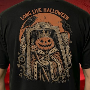 May include: A black t-shirt featuring a graphic print of a pumpkin-headed figure wearing a crown and royal robes, holding a pumpkin scepter inside a stone tomb. The text "LONG LIVE HALLOWEEN" appears above, with two black ravens and melting candles.