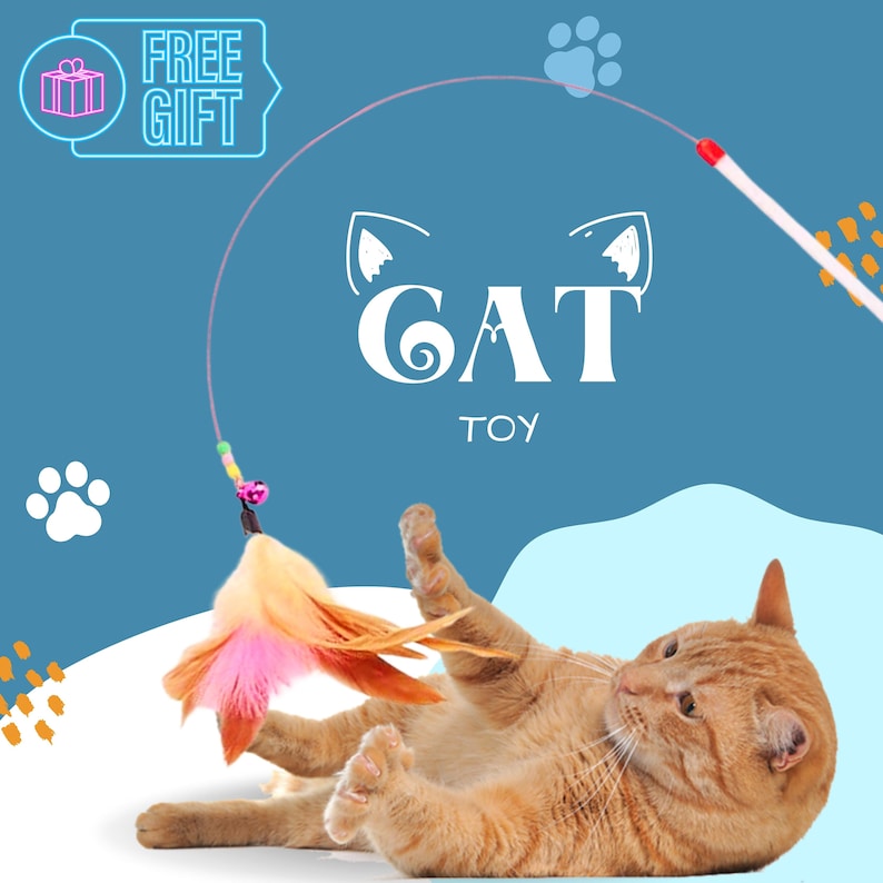 May include: A playful orange tabby cat batting at a pink and orange feather cat toy attached to a string. The toy is being held by a white wand with a red tip. The background is blue with the words "CAT TOY" in white.