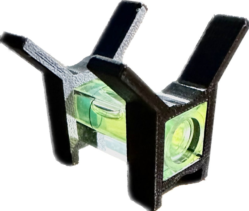 May include: A black plastic level with two arms extending out. The level has a clear glass tube with a green liquid inside. The level is designed to be used for checking if a surface is level.