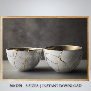 May include: Two white ceramic bowls with gold crackle glaze. The bowls are sitting on a grey background.
