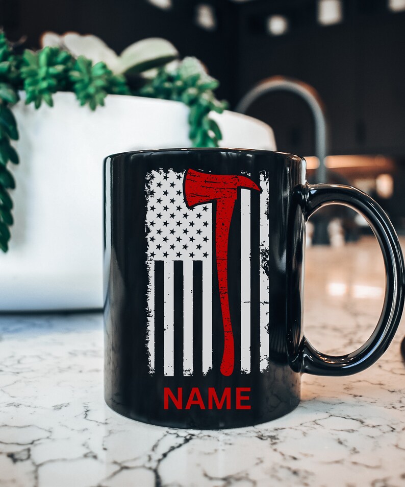 May include: Black coffee mug featuring a white and red American flag design with a red axe. The text "NAME" is printed below the flag.