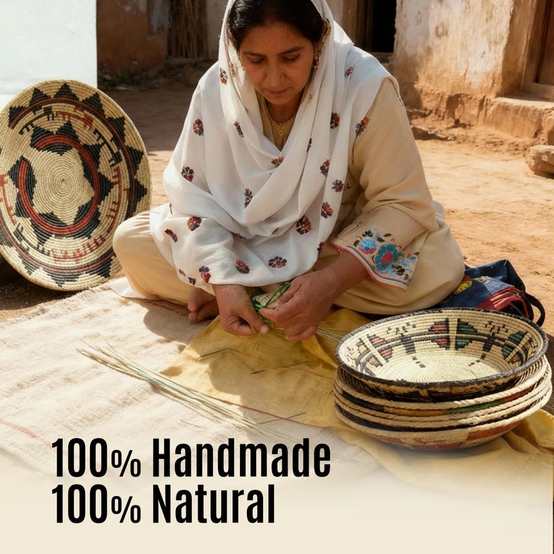 May include: A person wearing a beige outfit and a white headscarf with floral patterns, weaving straw baskets. Several round, patterned woven baskets are visible. The text 100% Handmade 100% Natural is printed at the bottom of the image.