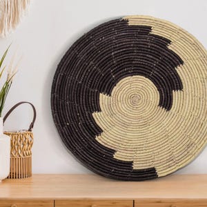 May include: A set of three ceramic mugs with a speckled, matte finish in cream, light grey, and dark grey. Each mug has a simple, minimalist design and a rounded handle.