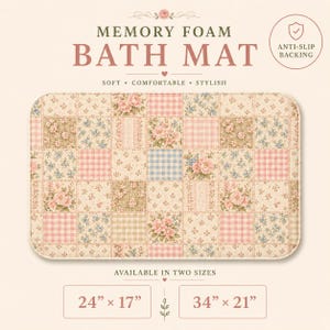 May include: A rectangular memory foam bath mat featuring a patchwork design of pink floral patterns, pink gingham, blue gingham, and small blue floral prints. Text reads: MEMORY FOAM BATH MAT, ANTI-SLIP BACKING, AVAILABLE IN TWO SIZES, 24" x 17", 34" x 21".