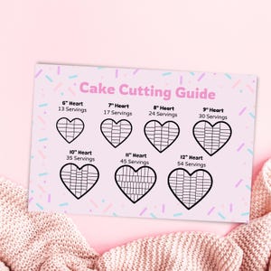 May include: A pink cake cutting guide with the text "Cake Cutting Guide" and heart-shaped cake diagrams. The guide shows how to cut heart-shaped cakes from 6 inches to 12 inches, with the number of servings for each size.