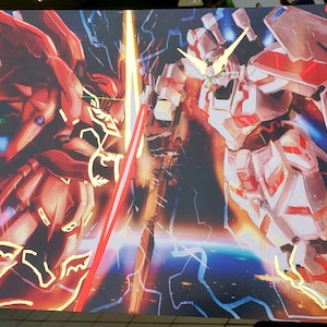 May include: A red and gold robot with a sword clashes with a white and red robot with a beam weapon in a space scene. The robots are surrounded by a blue and purple nebula.