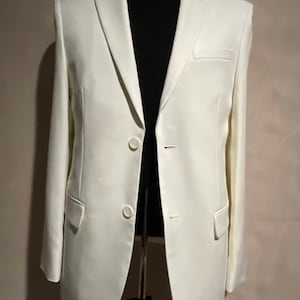 May include: A white blazer with a single button closure and two pockets.