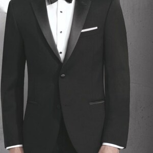May include: A black tuxedo jacket with a satin lapel and a single button closure. The jacket has a pocket on the left side and a white pocket square.