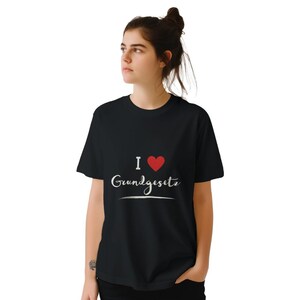 May include: Black t-shirt with white text that says "I ♥ Grundgesetz" with a red heart.
