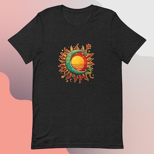 May include: A black t-shirt with a colorful graphic of a sun and moon. The sun is yellow and orange with a red center, and the moon is green with a white crescent shape. The graphic is surrounded by stars and other celestial elements.