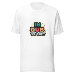 May include: White t-shirt with a colorful graphic that says "In Dub We Trust".