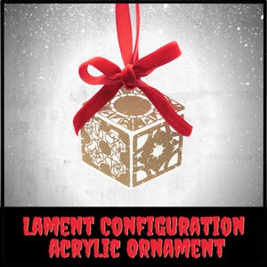 May include: A gold-colored acrylic ornament in the shape of a cube, with intricate geometric cutouts. It is suspended by a red velvet ribbon tied in a bow. The text "LAMENT CONFIGURATION ACRYLIC ORNAMENT" is displayed in red.
