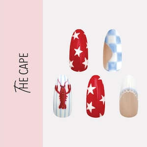 May include: A set of five artificial nails with various designs. Two nails are red with white stars, one has a blue and white checkered pattern, one has a red lobster on blue and white stripes, and one has a white lace design.