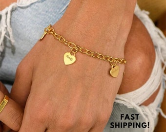 May include: Gold charm bracelet with heart-shaped charms engraved with the names "Emily" and "Wesley".