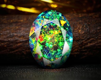 May include: An oval-cut gemstone with a vibrant display of colors, including green, blue, yellow, and red. The gem has a dark background, and the facets reflect light, creating a sparkling effect. The gemstone is a beautiful piece of jewelry.