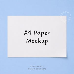 May include: A rectangular white A4 paper mockup centered on a light blue background. The paper features the black text A4 Paper Mockup in a simple handwritten font. A faint circular watermark with the text KAEFER DESIGNS is visible in the corner.