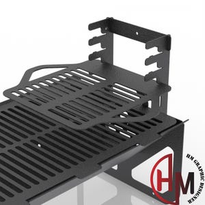 May include: A black metal rack with a textured finish, featuring a tiered design with slotted surfaces and a vertical back panel with notched edges. The structure includes a lower platform and an elevated shelf, with the text HM GRAPHIC DESIGNER.