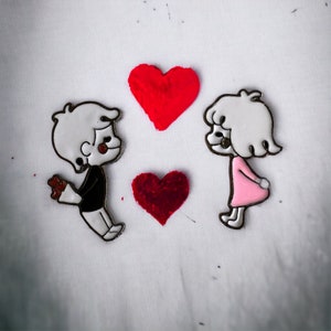 Girl with Pink Dress and Boy with Flowers Leaning in for a Kiss Pin - Add a Flirty Touch to Your Look: Unisex, Women&#39;s, Men&#39;s
