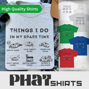 May include: A gray t-shirt with the text "Things I do in my spare time" and illustrations of cars. The shirt is available in different colors, including gray, green, blue, and red.