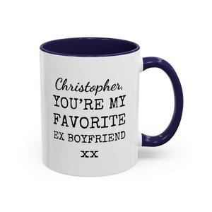 May include: White ceramic mug with a navy blue interior and handle. The mug features the text "Christopher, YOU'RE MY FAVORITE EX BOYFRIEND" in black, with "XX" below. A humorous gift.