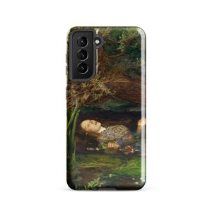 May include: A phone case featuring a painting of a woman floating in water, surrounded by flowers and greenery. The artwork depicts a serene scene with a natural, artistic aesthetic. The case is black with a camera module.