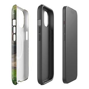 May include: A set of three phone cases. One case features a colorful, nature-themed design with green, brown, and white hues. The other two cases are solid black and gray. The cases are designed to protect the phone.