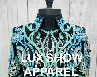 May include: A black show jacket with turquoise and green embroidery and rhinestones. The jacket has a zipper closure and long sleeves. The text "LUX SHOW APPAREL" is embroidered on the front of the jacket.