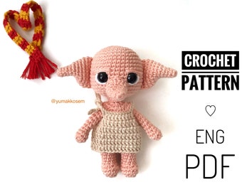 May include: Crochet pattern for a pink and beige amigurumi house elf doll. The pattern is in English and is available as a PDF download. The doll is wearing a beige dress and has large black eyes.