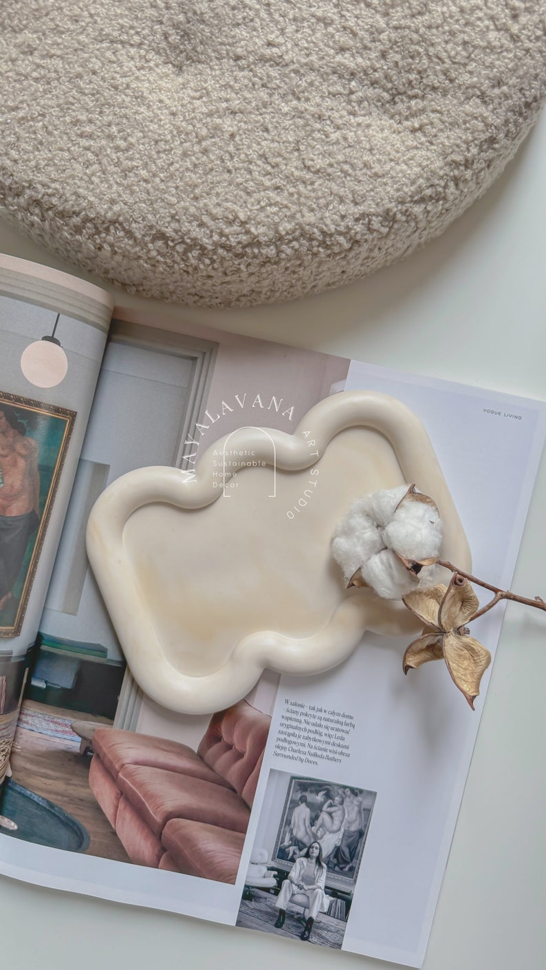 May include: A white ceramic tray with a unique, organic shape. The tray is sitting on a magazine with the text "Mayalavana Art Studio" and "Aesthetic Sustainable Home Decor".