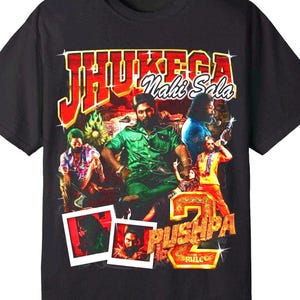 May include: Black t-shirt featuring a colorful graphic design with the text "JHUKEEGA Nahi Sala" in red and yellow. The design includes images of several people and the text "PUSHPA 2 RULE".